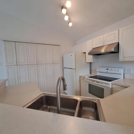 a kitchen that has a sink and a stove