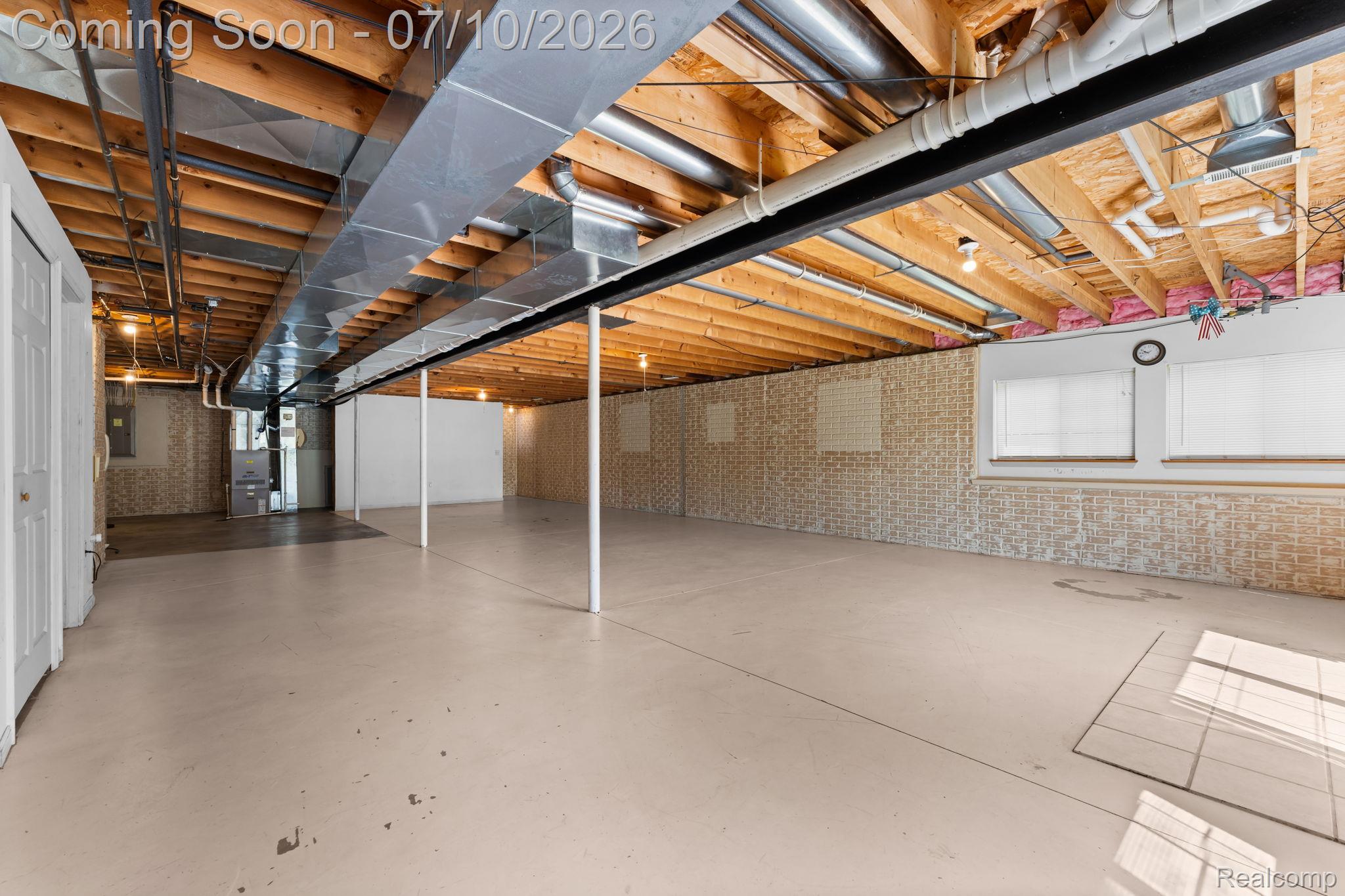 3144 North Nicholson Road Fowlerville, MI 48836 - Photo 68 of 70 Expansive unfinished basement featuring a concrete floor, exposed wood ceiling joists, and visible utility infrastructure