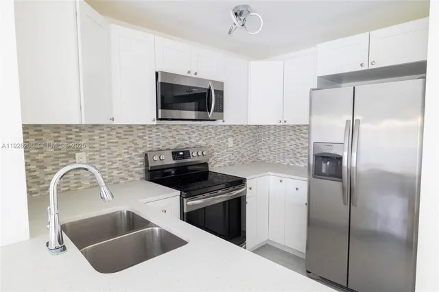 a kitchen with a refrigerator sink and microwave