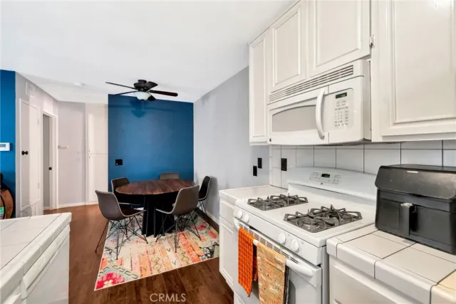 a kitchen that has a stove and a table