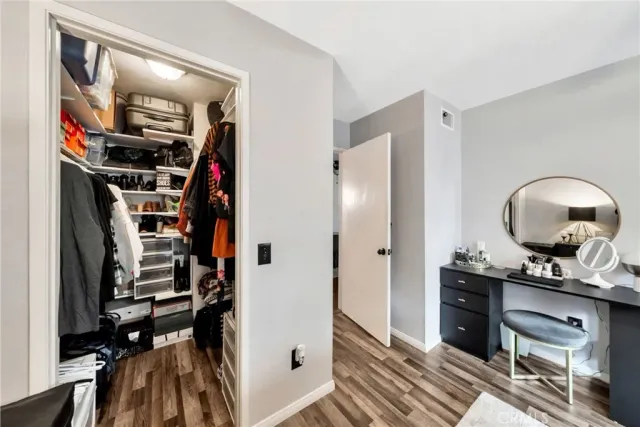 a view of a hallway with workspace and closet