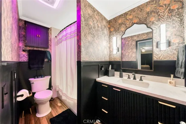 a bathroom with a sink vanity mirror and toilet