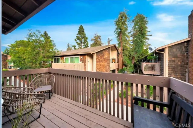 a view of a wooden deck and a backyard