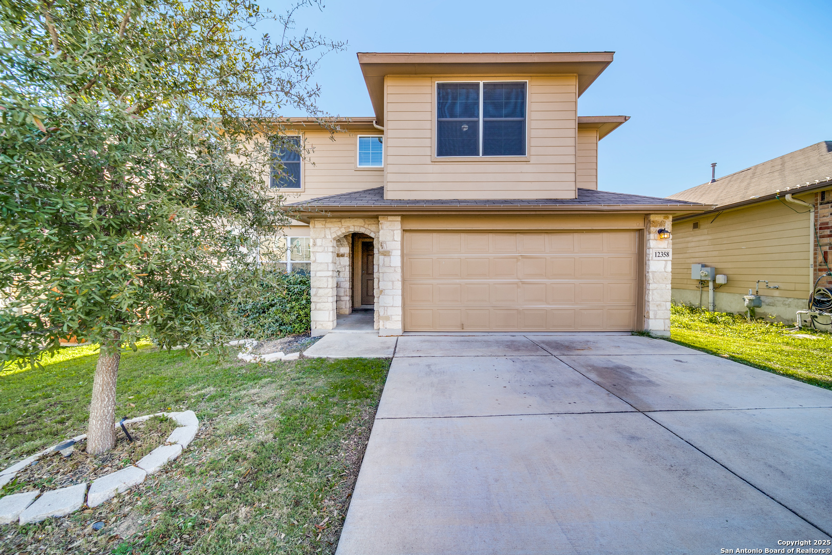12358 Erstein Schertz, TX 78154 - Photo 1 of 8 a front view of a house with a yard and garage