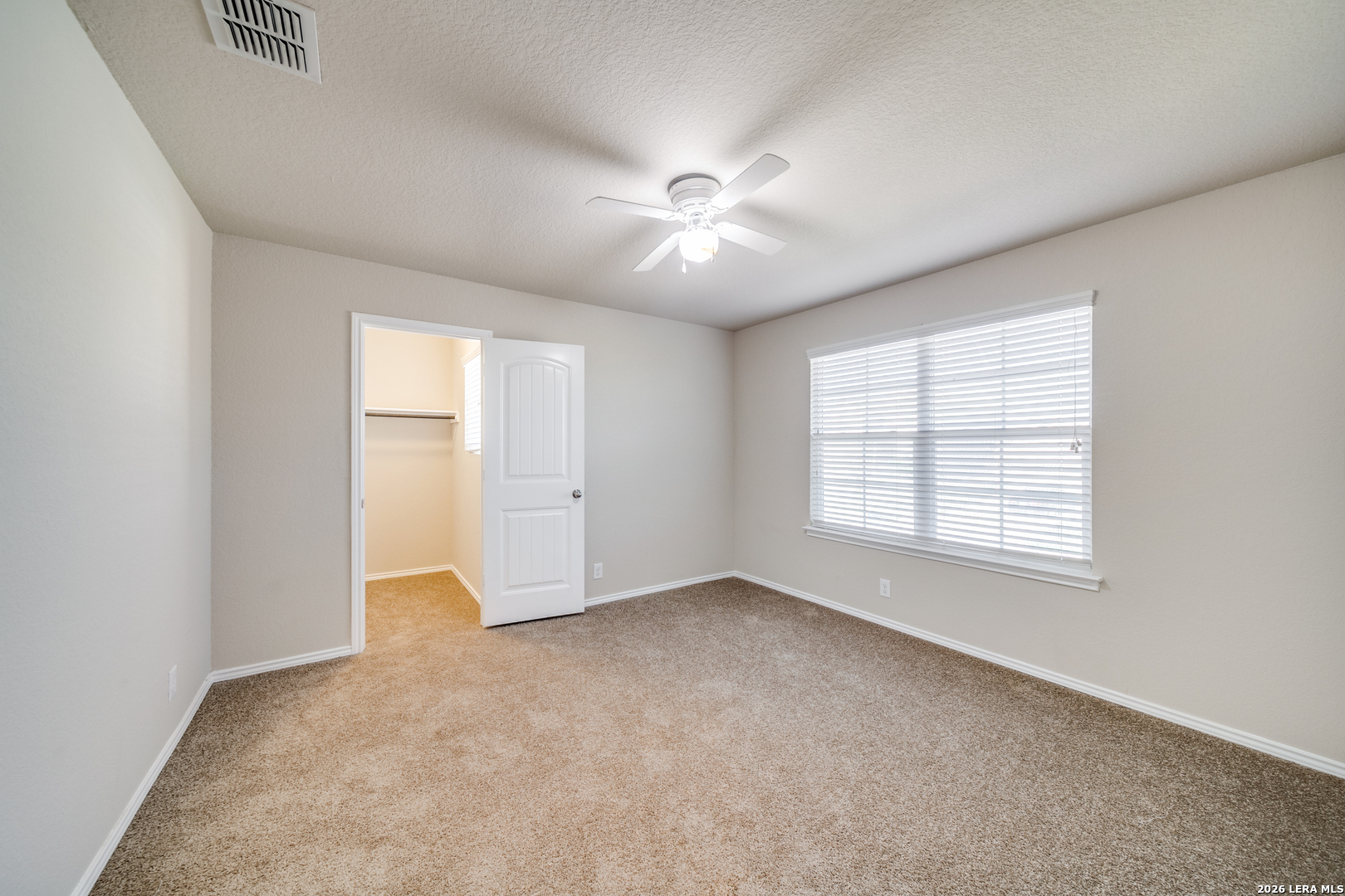12358 Erstein Schertz, TX 78154 - Photo 11 of 21 an empty room with chandelier fan and windows