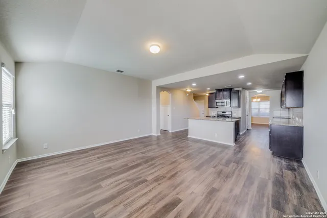 a view of kitchen and hall with wooden floor