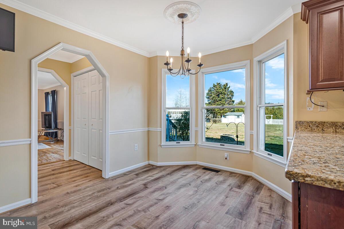 12630 Grosstown Road Hughesville, MD 20637 - Photo 13 of 44 a view of a room with wooden floor fireplace and windows