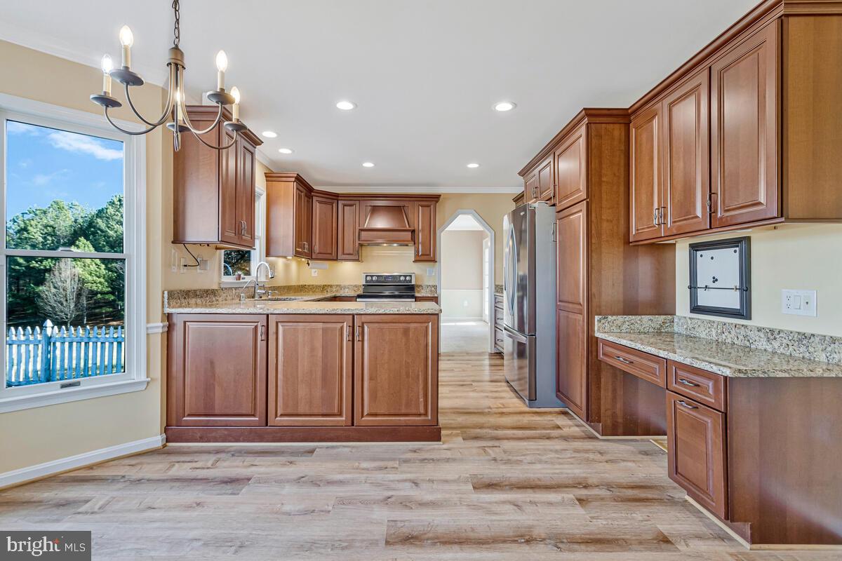 12630 Grosstown Road Hughesville, MD 20637 - Photo 14 of 44 a kitchen with stainless steel appliances granite countertop a refrigerator a sink dishwasher a stove and a oven with wooden floor