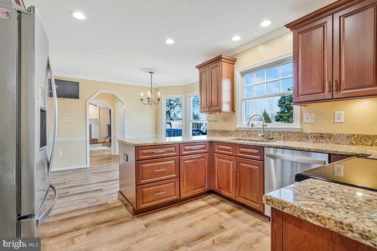 12630 Grosstown Road Hughesville, MD 20637 - Photo 17 of 44 a kitchen with stainless steel appliances kitchen island granite countertop wooden cabinets a sink and dishwasher