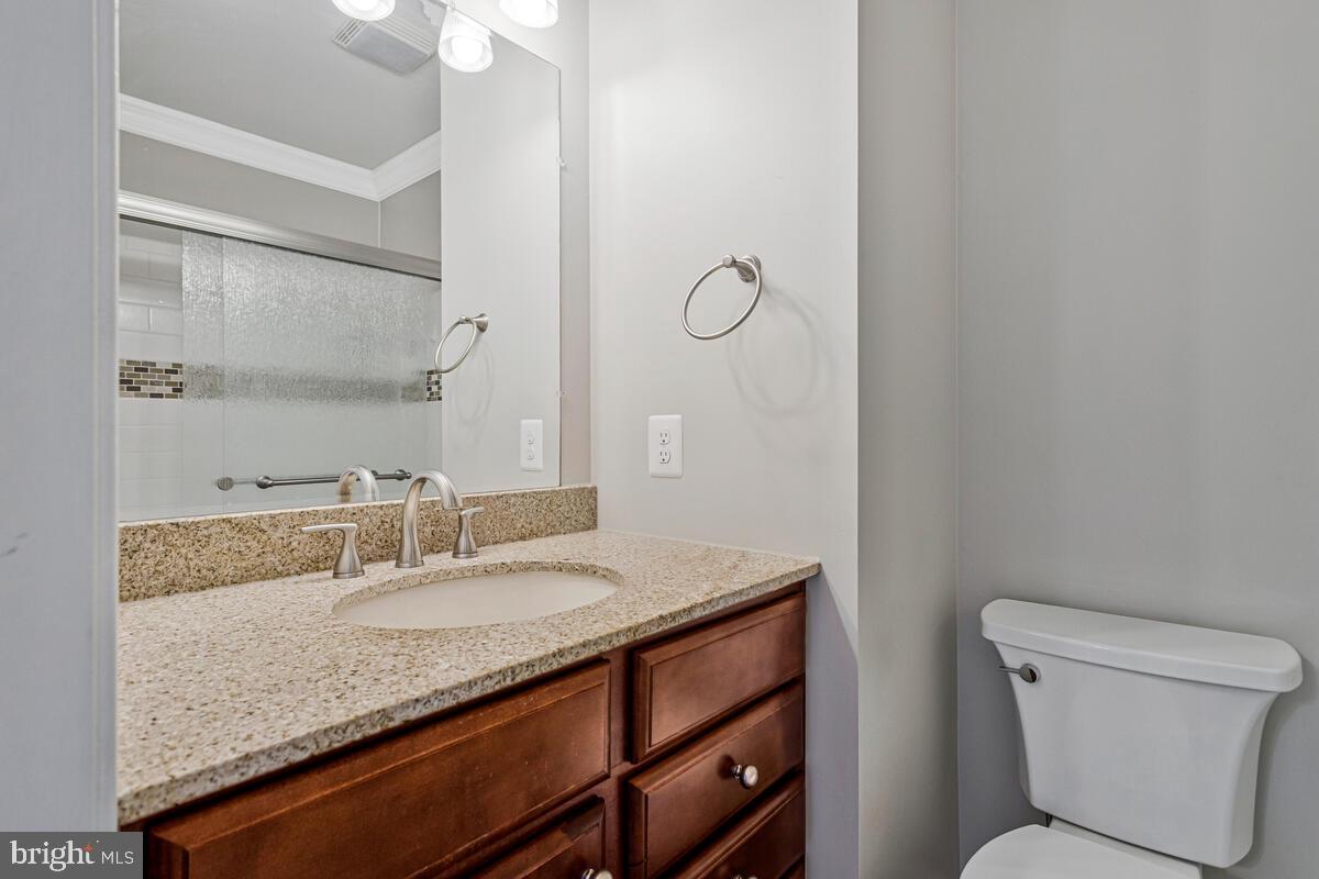 12630 Grosstown Road Hughesville, MD 20637 - Photo 26 of 44 a bathroom with a granite countertop sink a toilet and a mirror