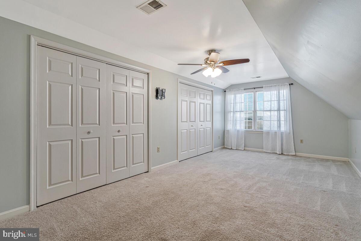 12630 Grosstown Road Hughesville, MD 20637 - Photo 27 of 44 an empty room with chandelier fan and windows