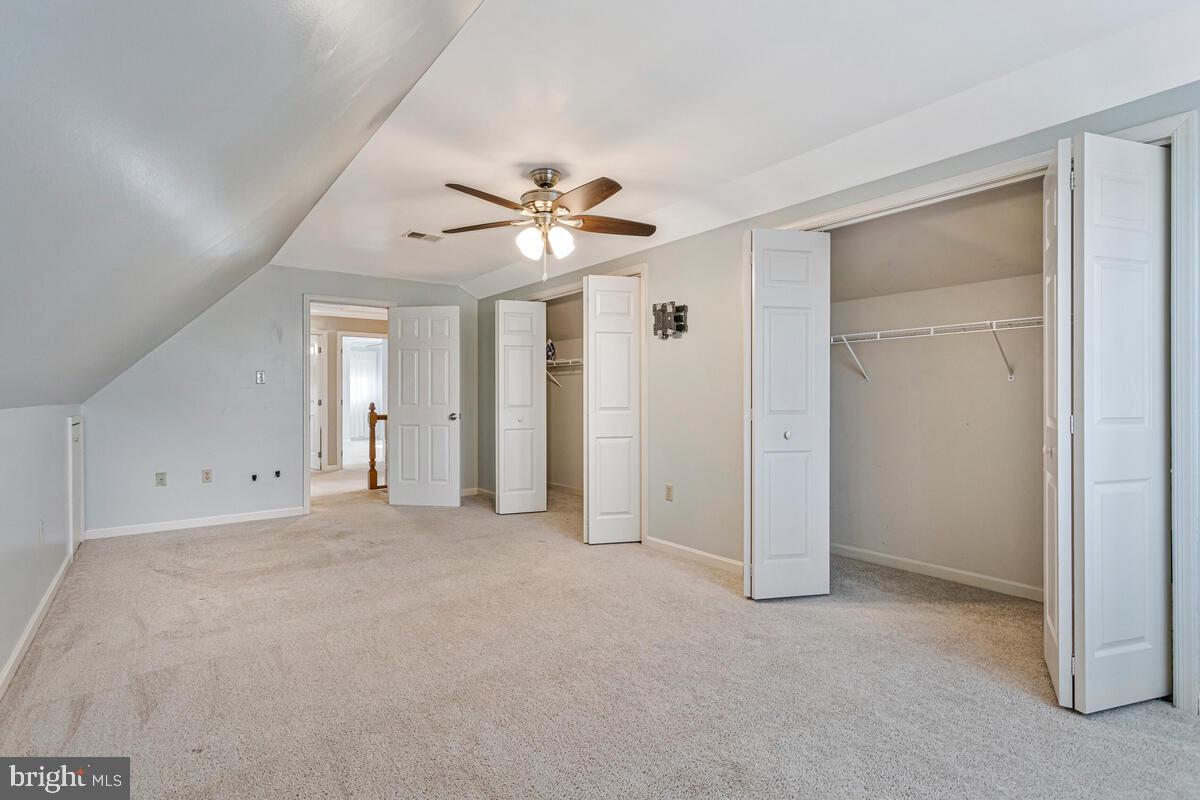 12630 Grosstown Road Hughesville, MD 20637 - Photo 29 of 44 an empty room with chandelier fan and windows