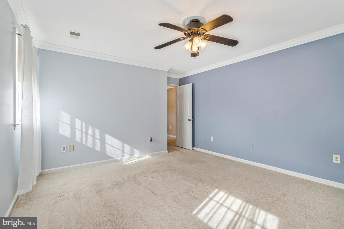 12630 Grosstown Road Hughesville, MD 20637 - Photo 33 of 44 a view of a big room with a ceiling fan and a window