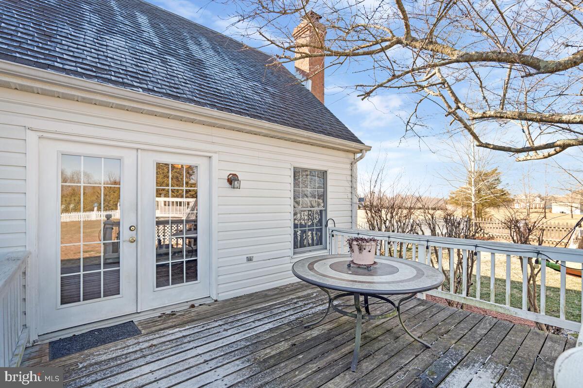 12630 Grosstown Road Hughesville, MD 20637 - Photo 39 of 44 a view of a balcony with table and chairs