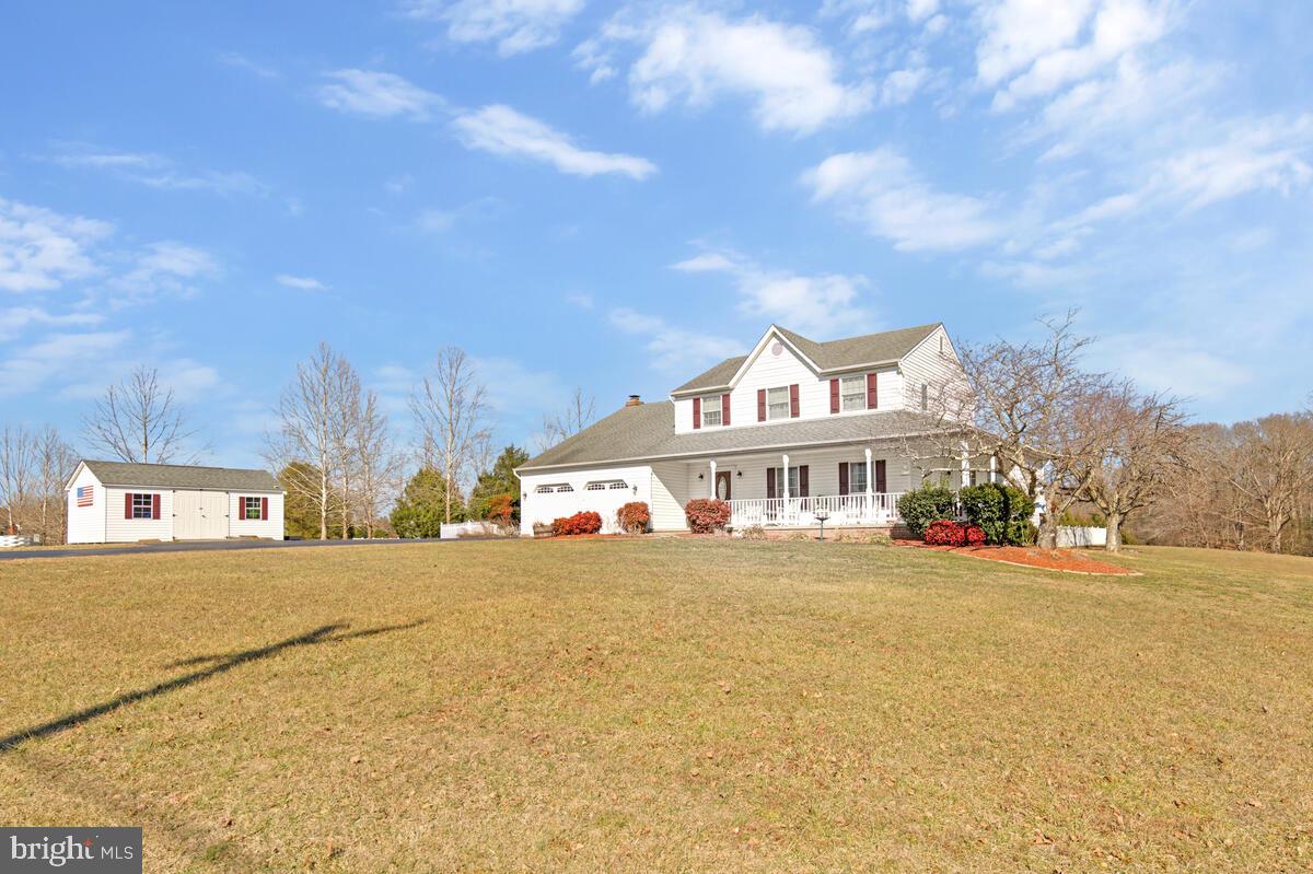 12630 Grosstown Road Hughesville, MD 20637 - Photo 4 of 44 a view of a white house with a big yard and large trees