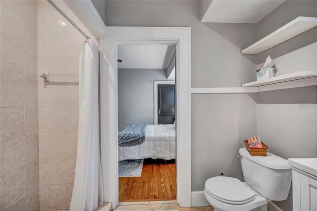 a bathroom with a toilet and a shower