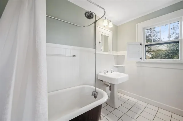 a bathroom with a sink a mirror and a bathtub