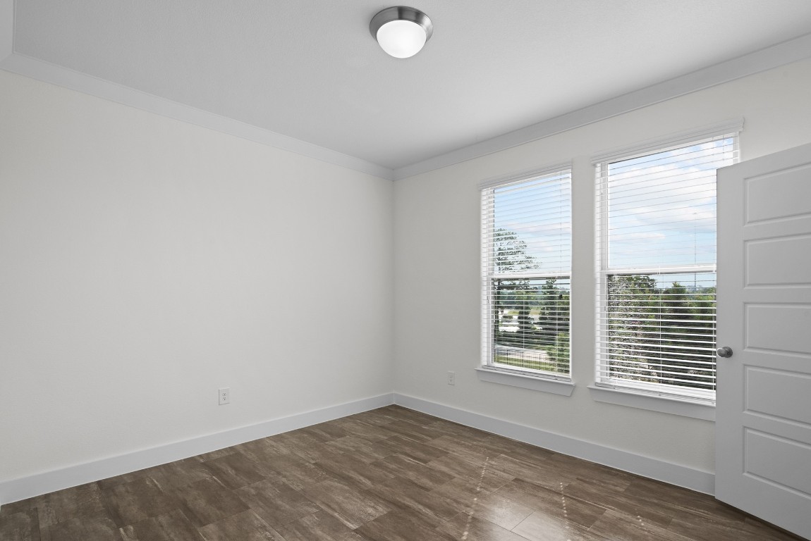 366 Fm 1488 Road, Unit 937 Conroe, TX 77384 - Photo 12 of 24 an empty room with wooden floor and windows