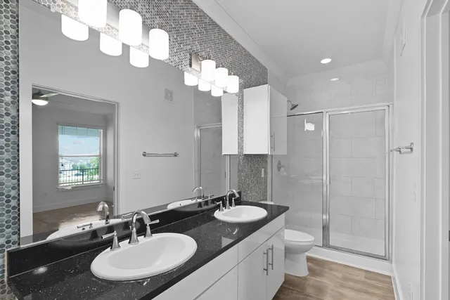 a bathroom with a sink double vanity and a mirror