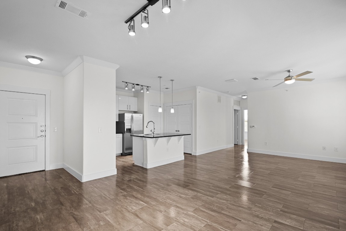 366 Fm 1488 Road, Unit 937 Conroe, TX 77384 - Photo 2 of 24 a view of kitchen and empty room with wooden floor
