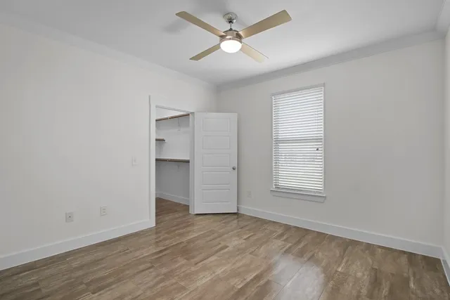 wooden floor in an empty room with a window