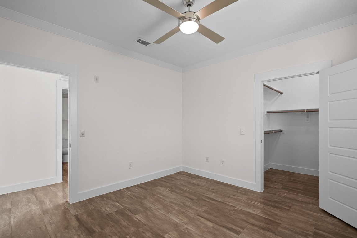 366 Fm 1488 Road, Unit 937 Conroe, TX 77384 - Photo 10 of 24 an empty room with wooden floor and ceiling fan