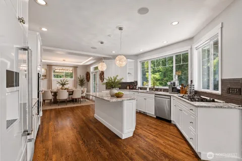 a kitchen with lots of counter top space and wooden floor