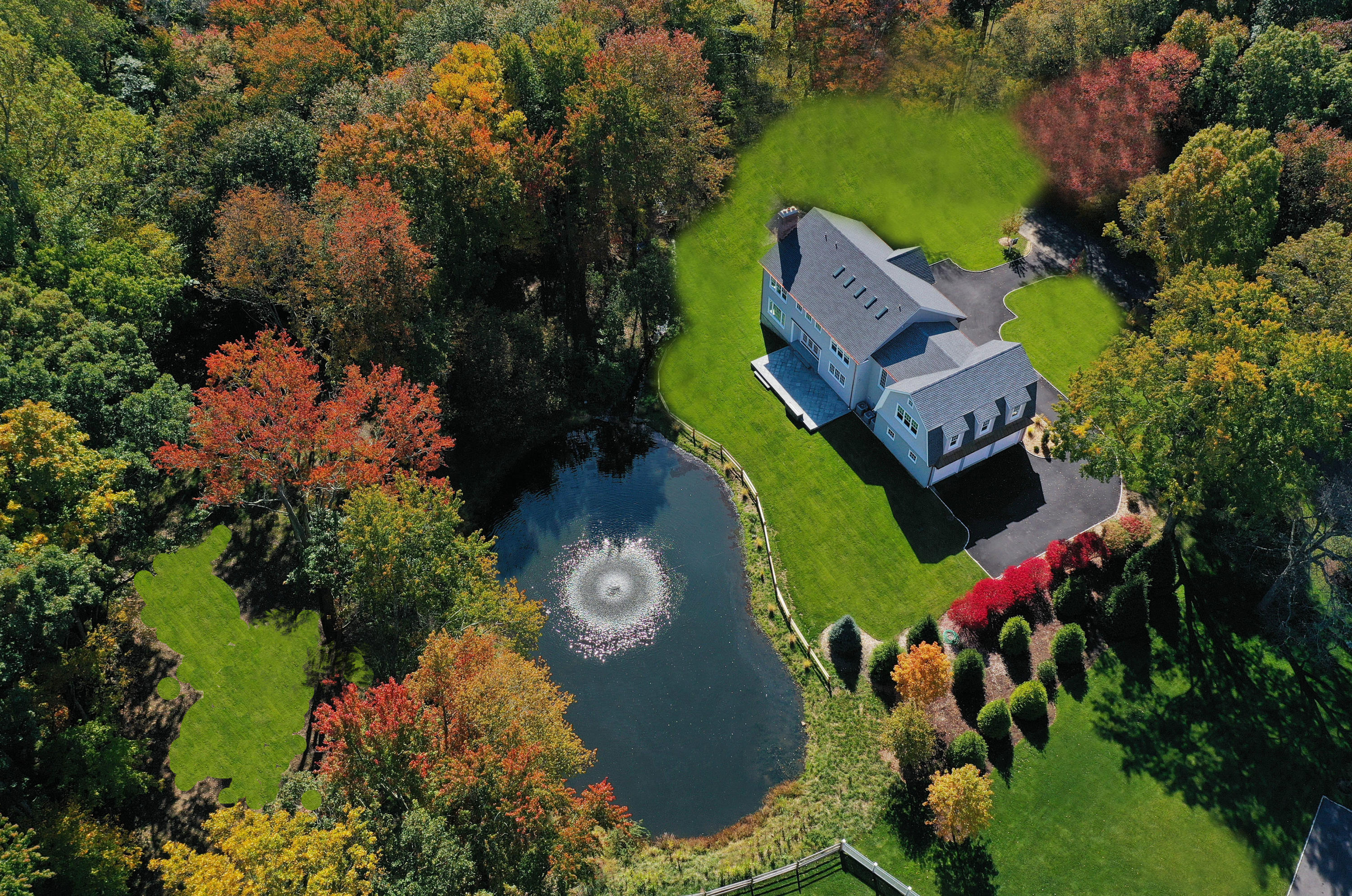 an aerial view of a house with a yard and garden