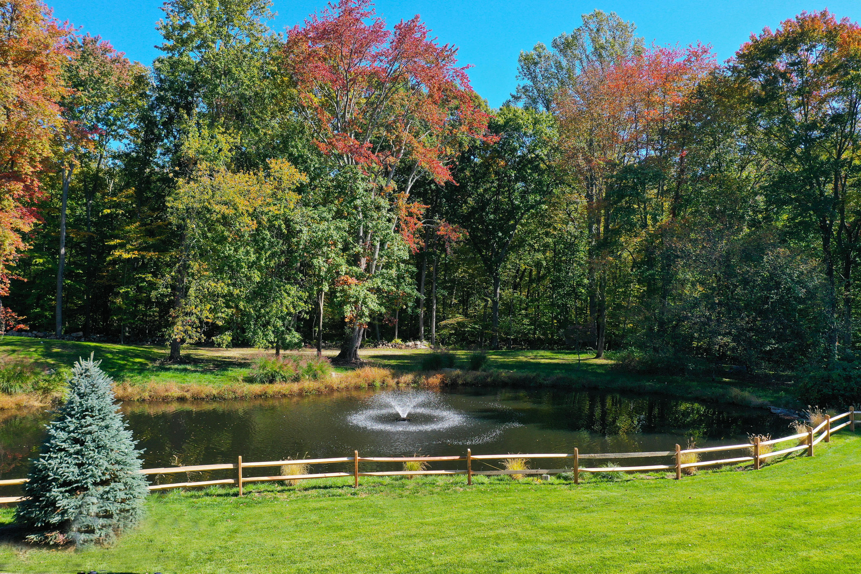 6 Valley Forge Road Darien, CT 06820 - Photo 3 of 3 a view of a lake with houses in the background