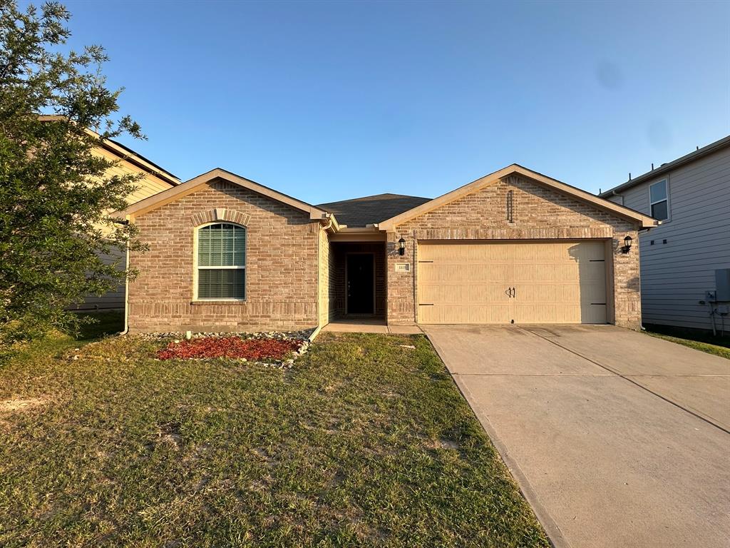 1818 Clegg Street Howe, TX 75459 - Photo 3 of 34 Brick facade residence featuring an arched window, a two-car garage with decorative hardware, and a concrete driveway