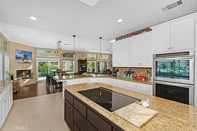 a kitchen with a stove a sink and a refrigerator