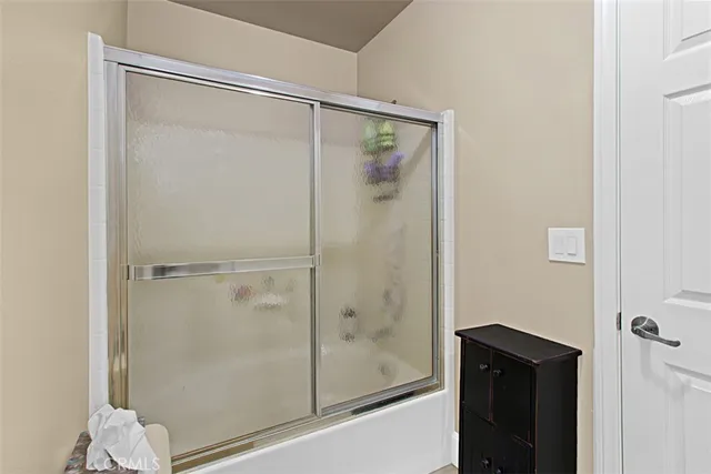 a bathroom with a glass shower door