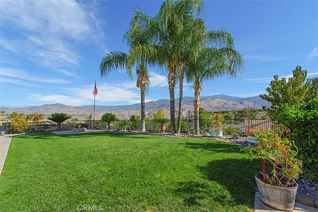 a view of a house with a yard and sitting area