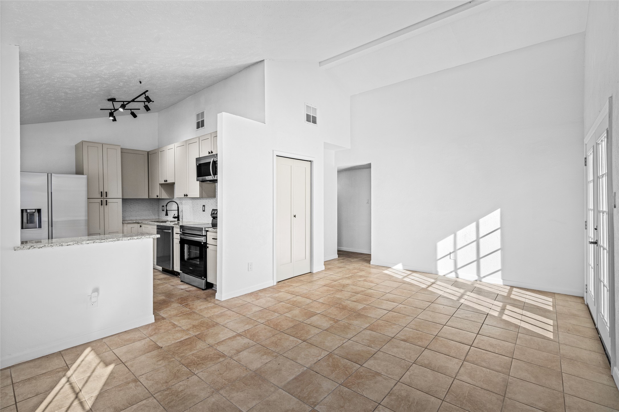 17510 Bullis Gap Drive Hockley, TX 77447 - Photo 21 of 21 a large white kitchen with white cabinets and stainless steel appliances