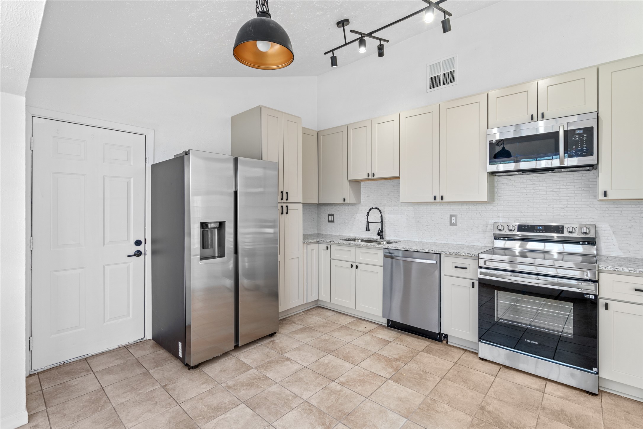 17510 Bullis Gap Drive Hockley, TX 77447 - Photo 7 of 21 a kitchen with stainless steel appliances granite countertop a refrigerator and a stove top oven