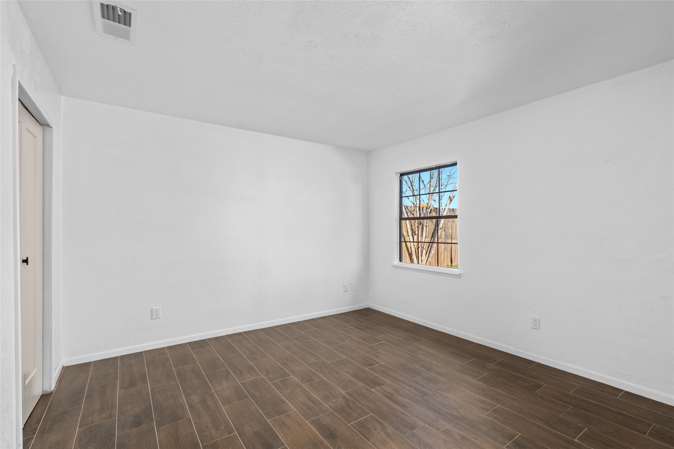 17510 Bullis Gap Drive Hockley, TX 77447 - Photo 9 of 21 an empty room with wooden floor and windows