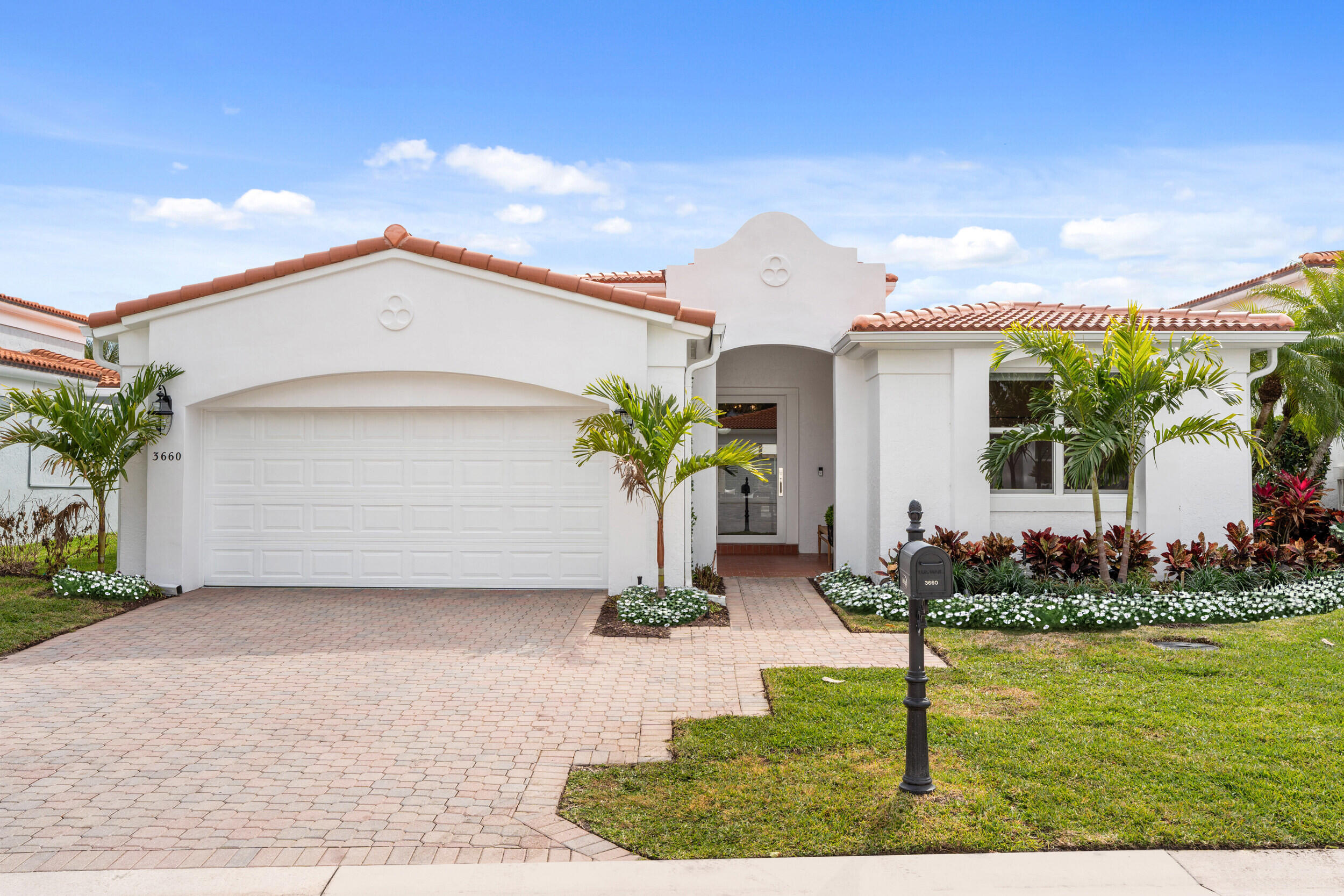 3660 Northwind Court Jupiter, FL 33477 - Photo 3 of 69 a front view of a house with garden