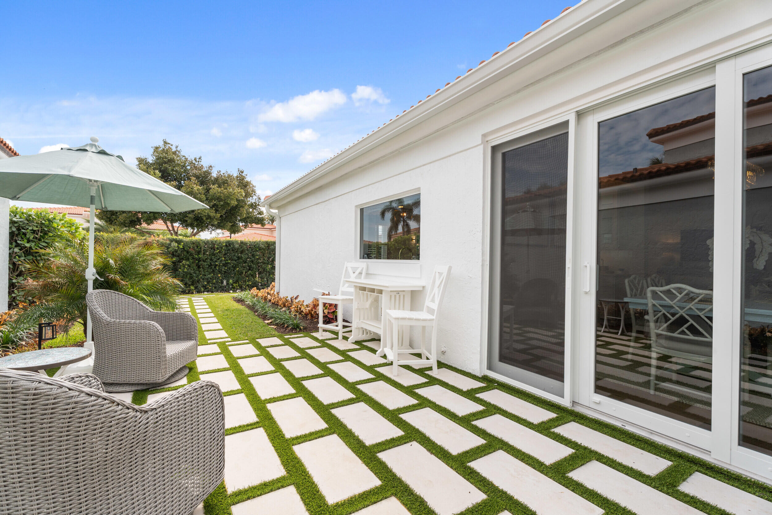 3660 Northwind Court Jupiter, FL 33477 - Photo 42 of 69 a view of a patio with table and chairs potted plants with wooden floor and fence