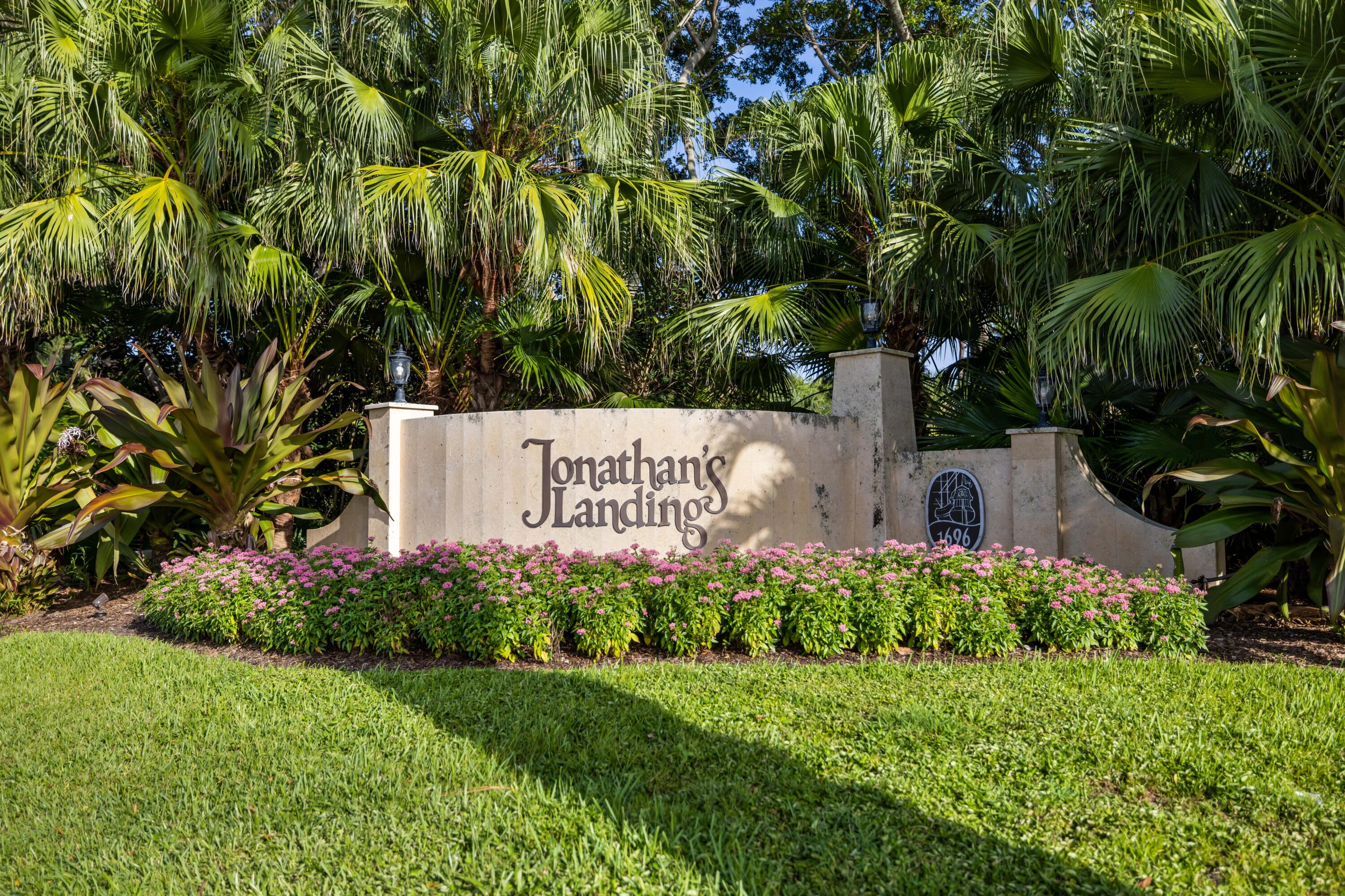 3660 Northwind Court Jupiter, FL 33477 - Photo 52 of 69 a sign of golf club on a wall under a tree