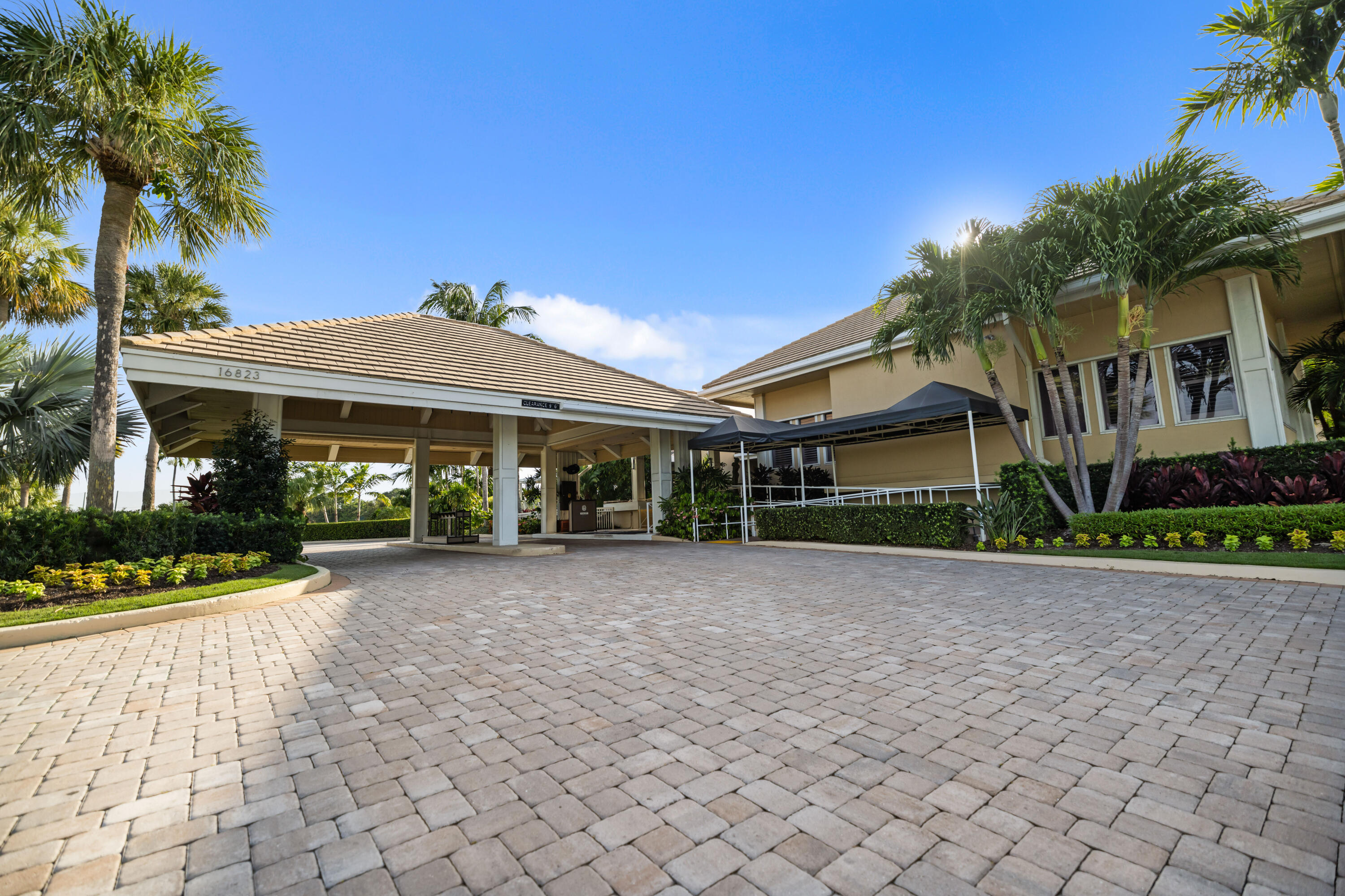 3660 Northwind Court Jupiter, FL 33477 - Photo 54 of 69 a front view of a house with a yard and potted plants