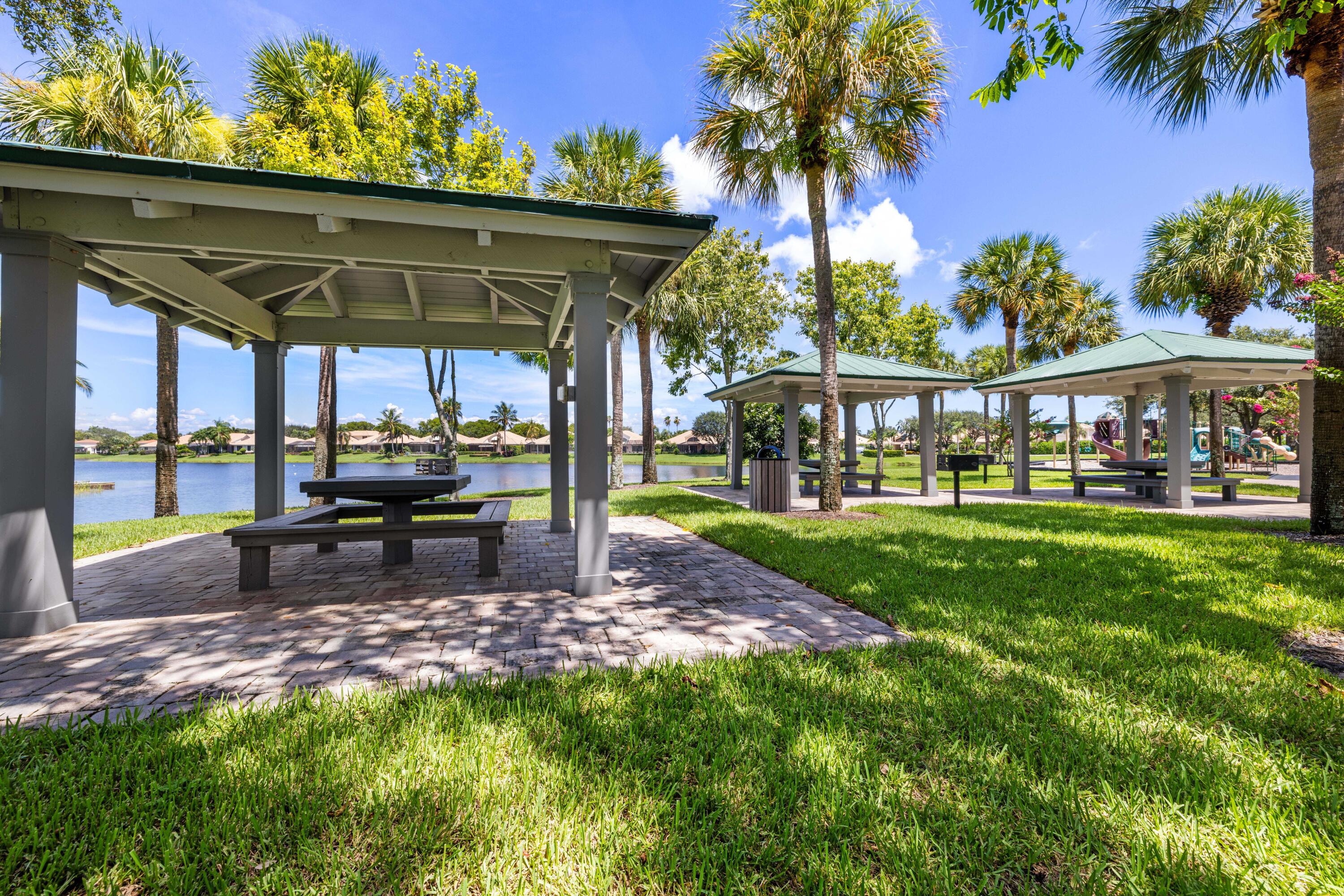 3660 Northwind Court Jupiter, FL 33477 - Photo 63 of 69 a view of a patio with a table chairs and a yard