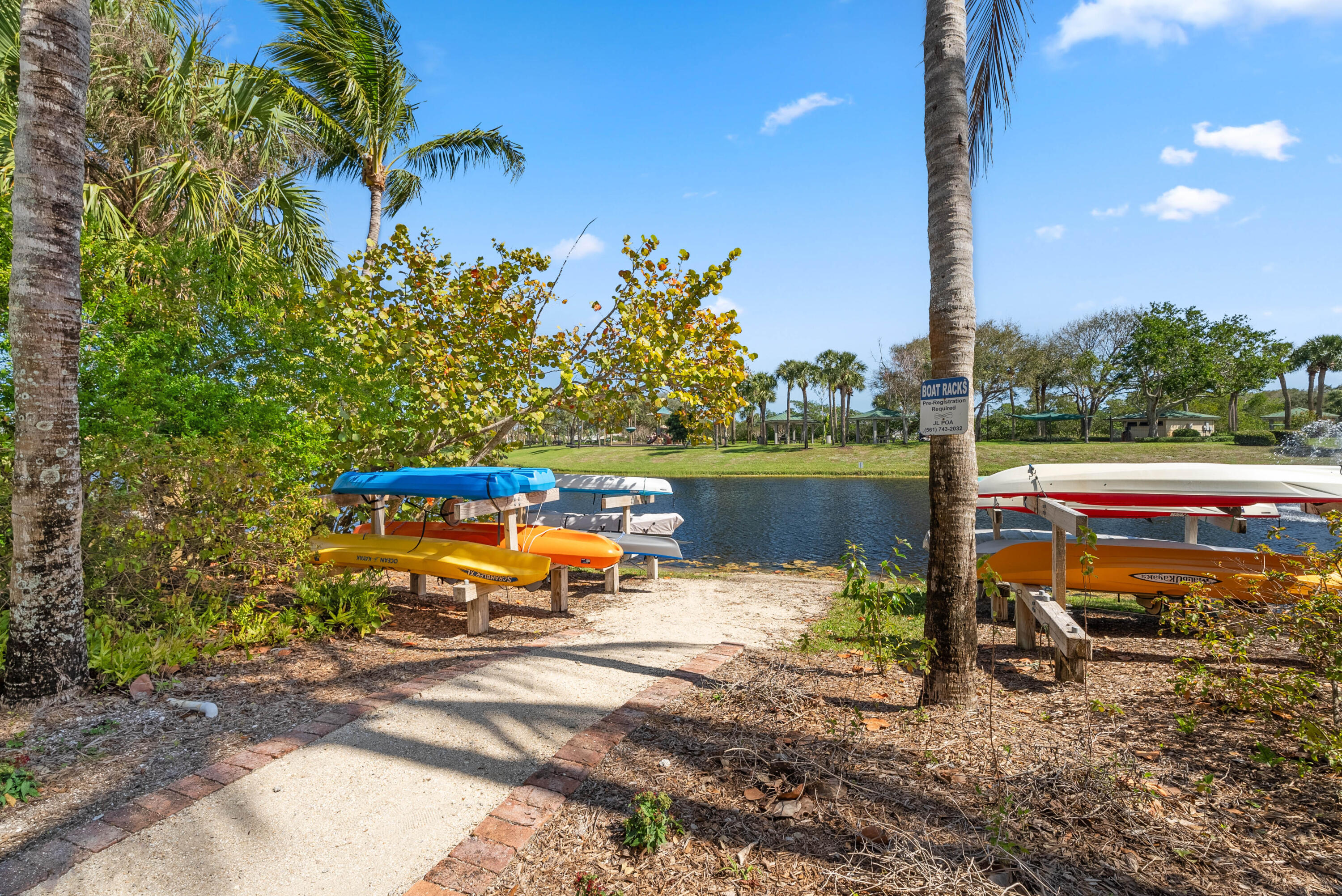 3660 Northwind Court Jupiter, FL 33477 - Photo 66 of 69 a view of a lake with a table and chairs