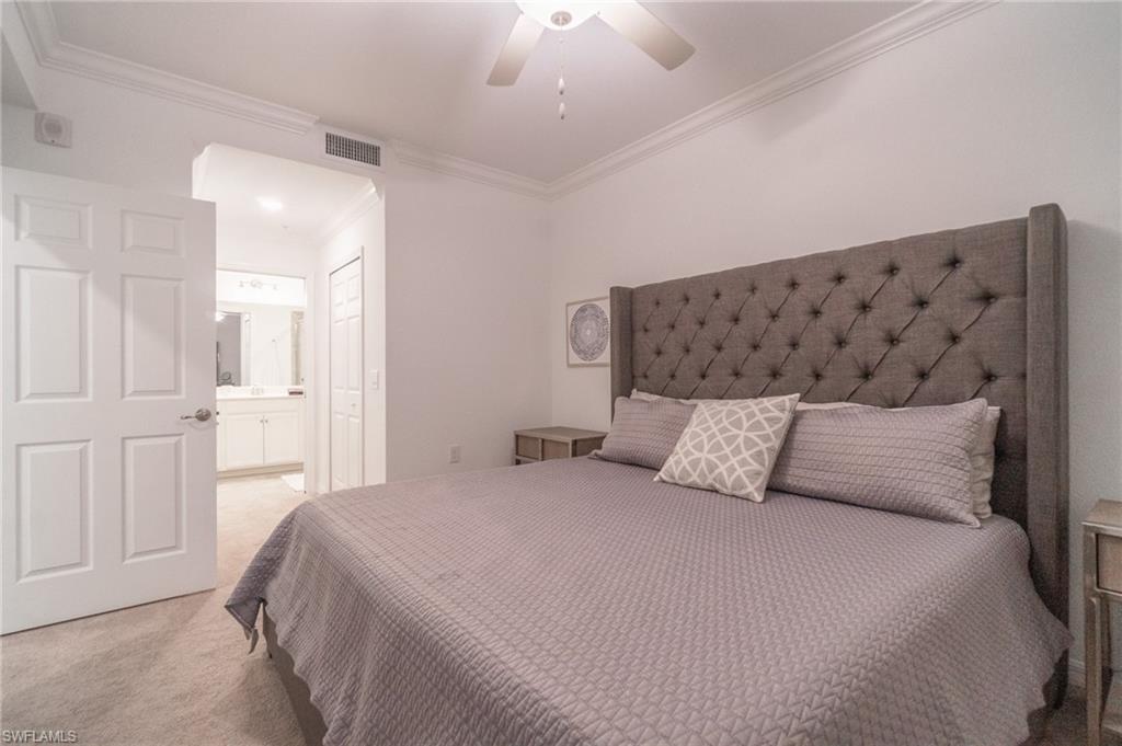 9596 Trevi Court, Unit 5426 Naples, FL 34113 - Photo 14 of 21 a bedroom with a bed and painting on the wall