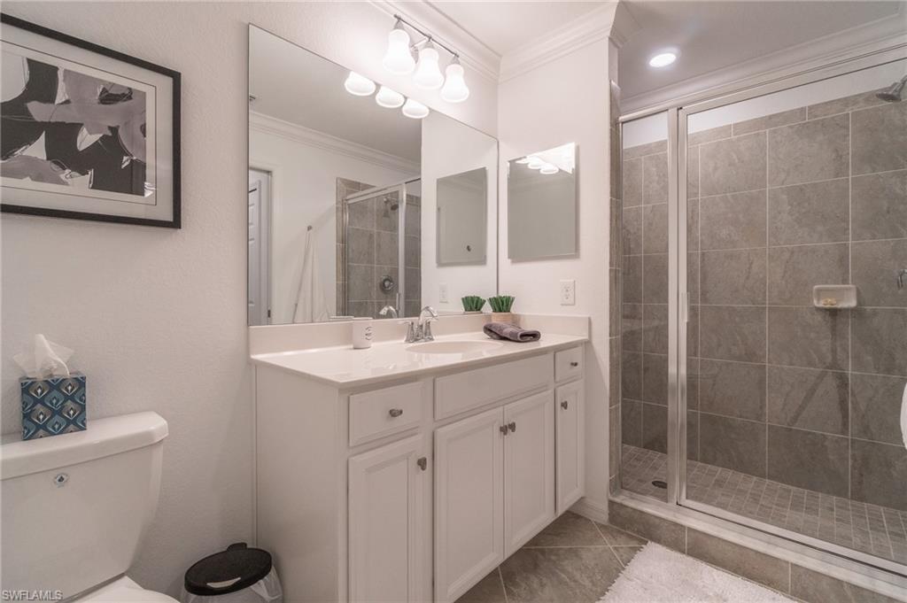 9596 Trevi Court, Unit 5426 Naples, FL 34113 - Photo 16 of 21 a bathroom with a shower sink and mirror