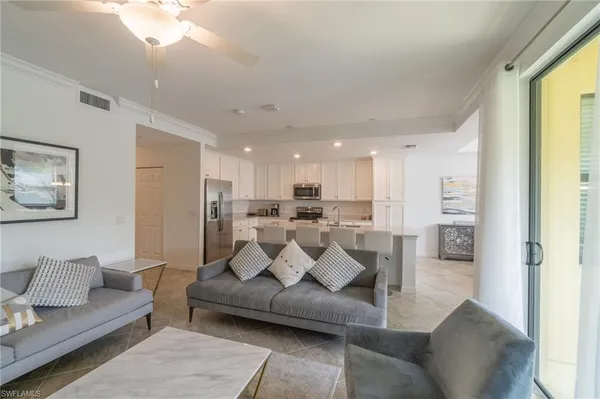 a living room with furniture and a large window