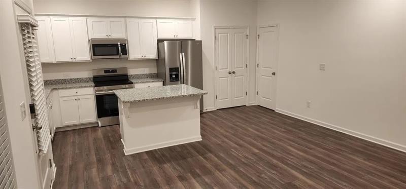 228 Banner Road Pendergrass, GA 30567 - Photo 7 of 8 a kitchen with a refrigerator and a stove top oven