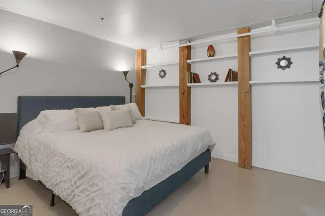 a large bed sitting in a bedroom next to a cabinet