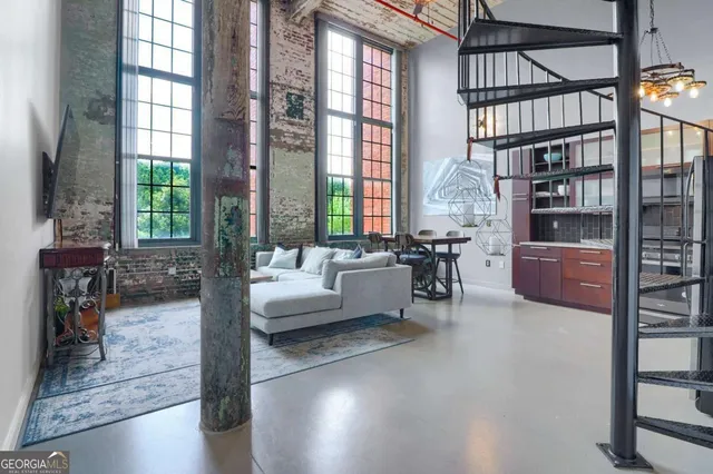 a living room with furniture and a potted plant