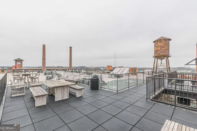 a view of roof deck with table and chairs