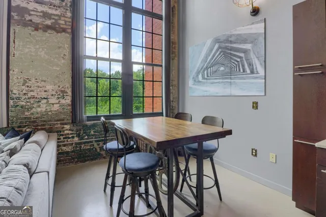 a view of a dining room with furniture and window